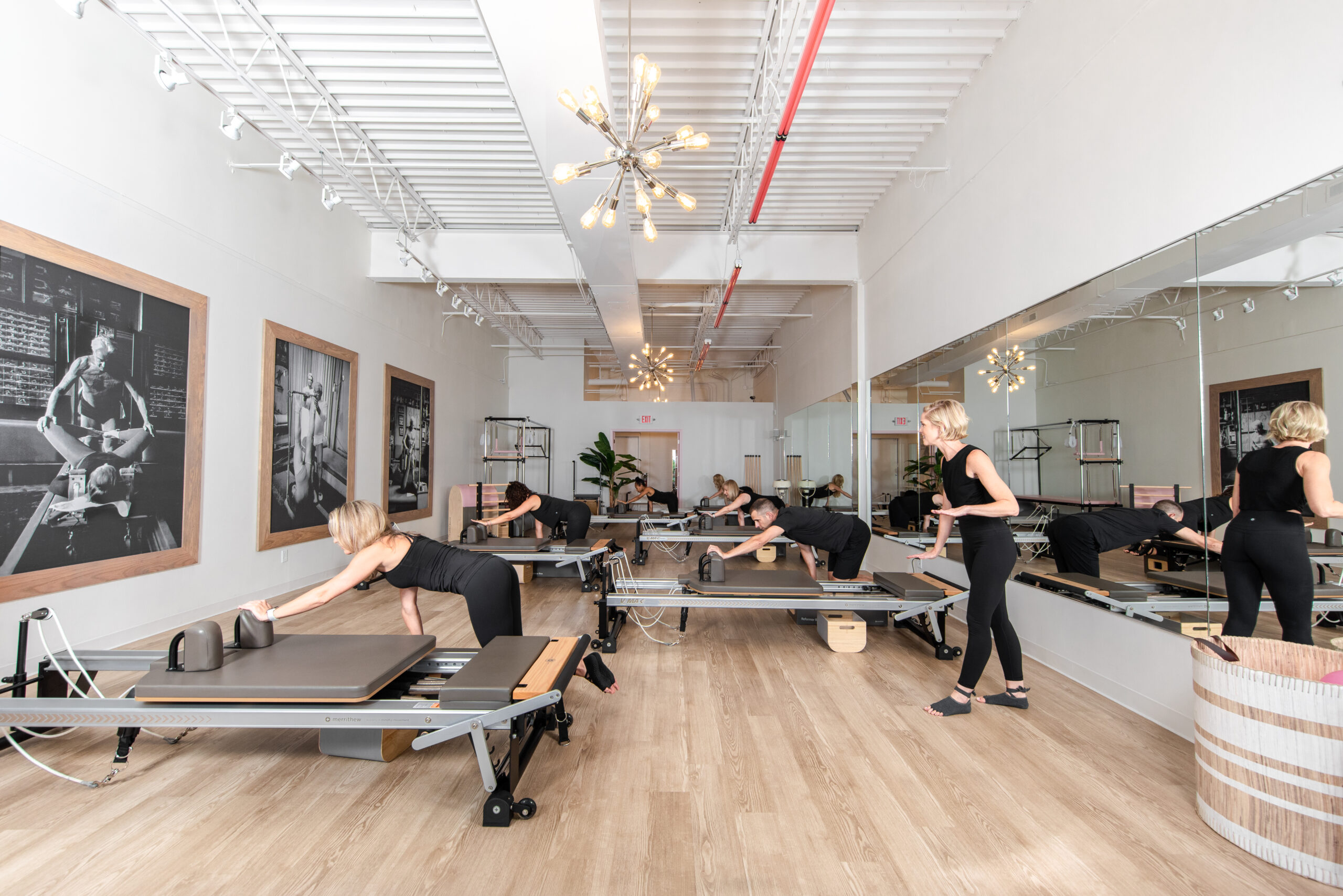 woman and men in pilates reformer class