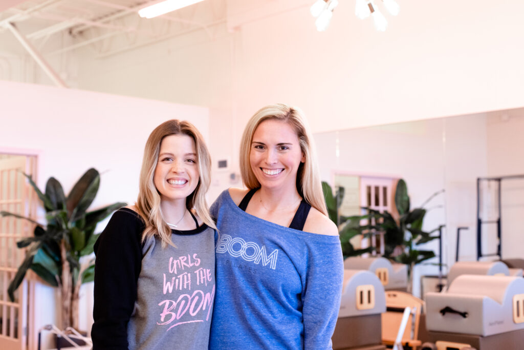 two women standing side by side and smiling 