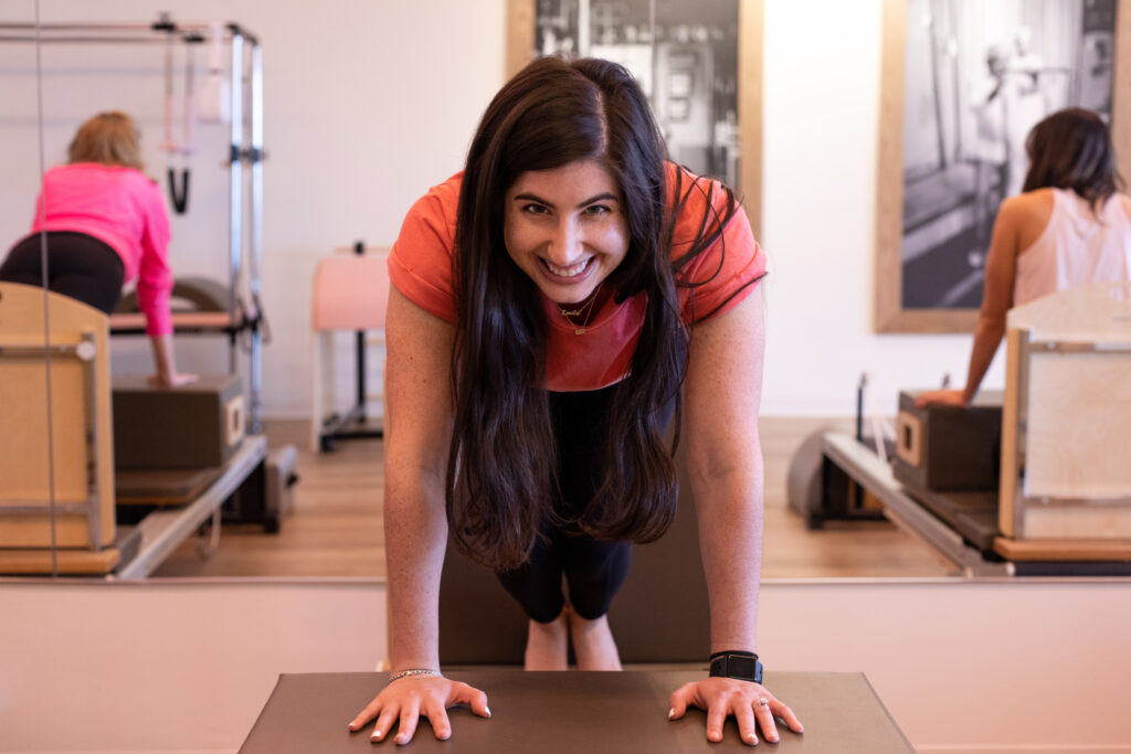 smiling woman on pilates reformer 